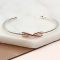 Sterling silver and rose gold infinity bangle
